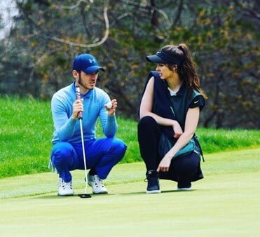 author and husband picture on golf course