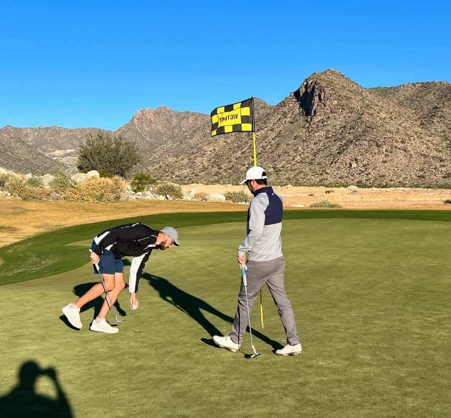 Fixing a ball mark on a green at a golf course in AZ